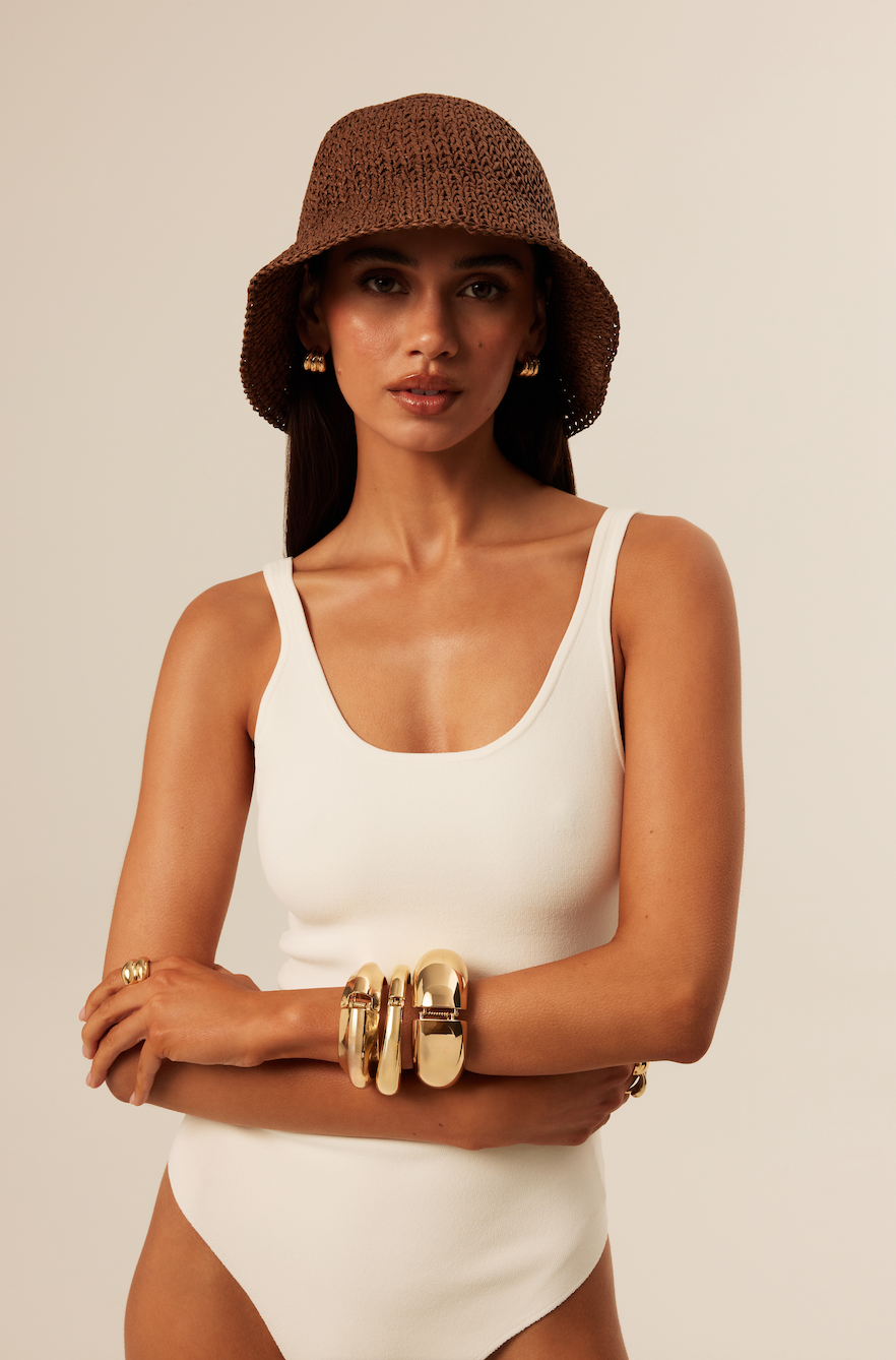 designed for clean product display, bucket hat and jewelry are adjusted through tonal correction and skin cleanup for ecommerce store imagery