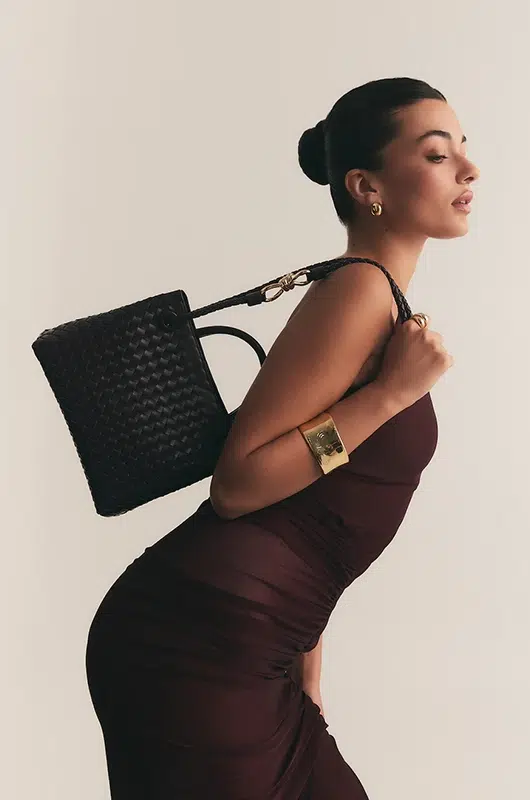 woven leather handbag corrected for texture clarity, stitching visibility and hardware definition for premium catalog presentation