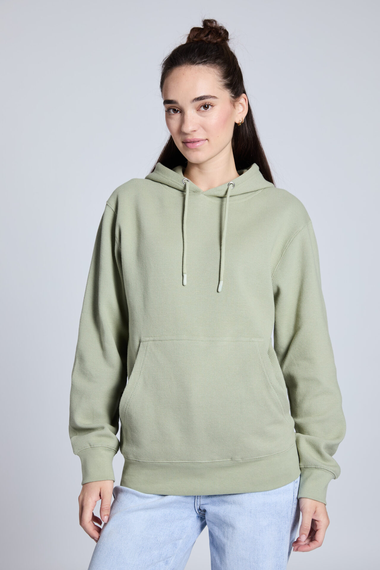 Fashion model in a green hoodie showing accurate garment color and natural color reproduction