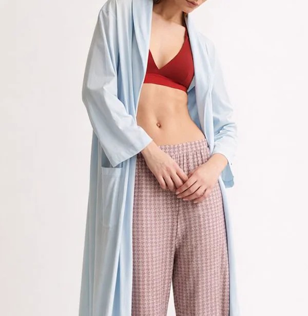 Model wearing layered clothing with natural shadow and depth balance across product imagery